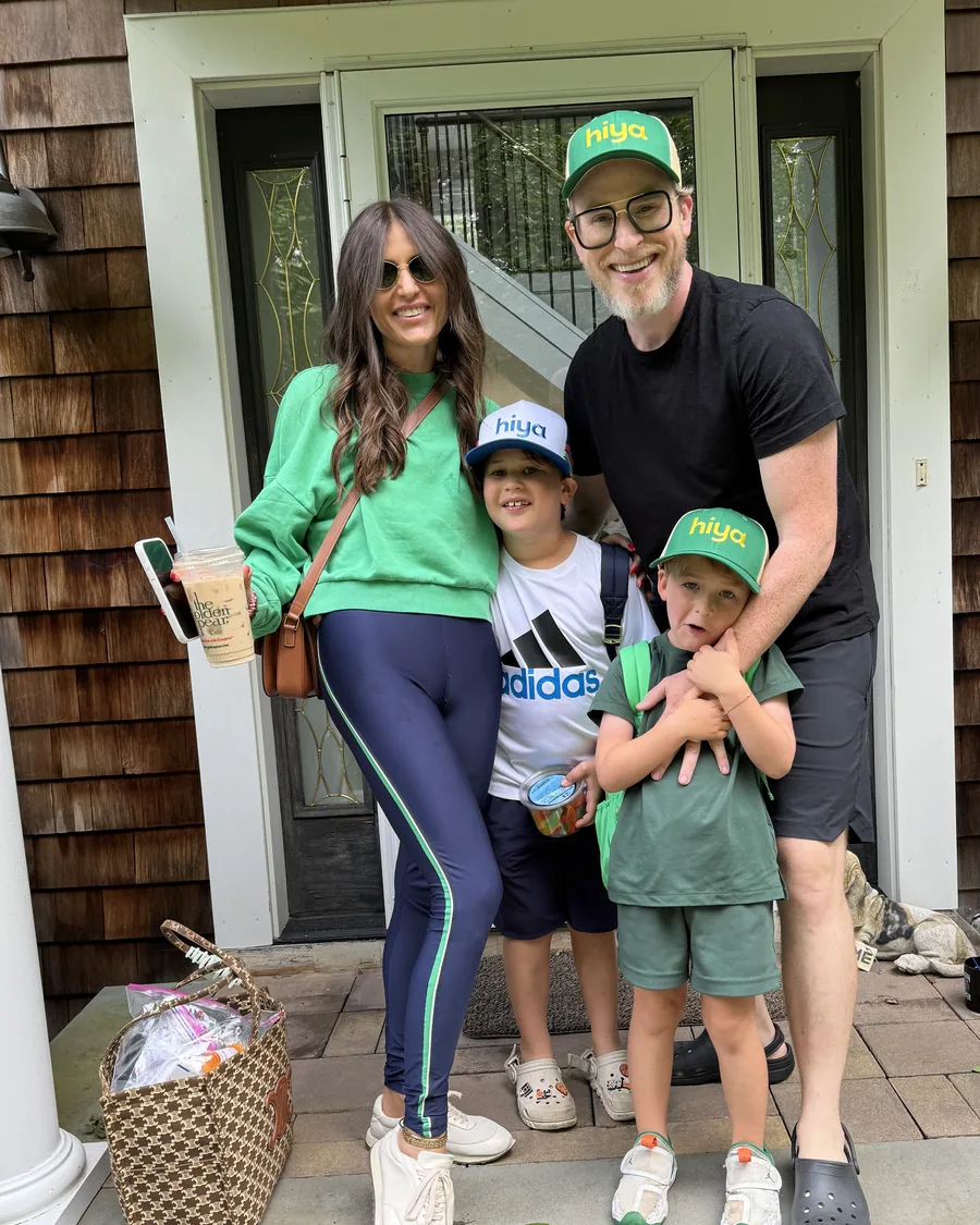 Adam with Lara and their two sons on their front porch